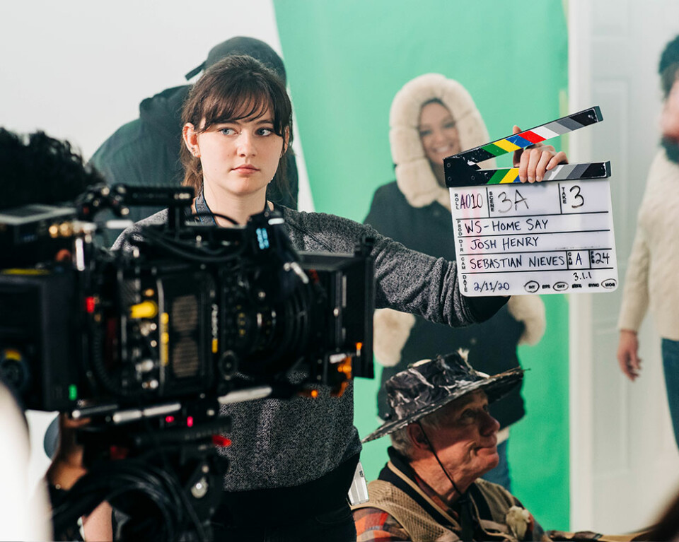 woman holding clapperboard for commercial scene